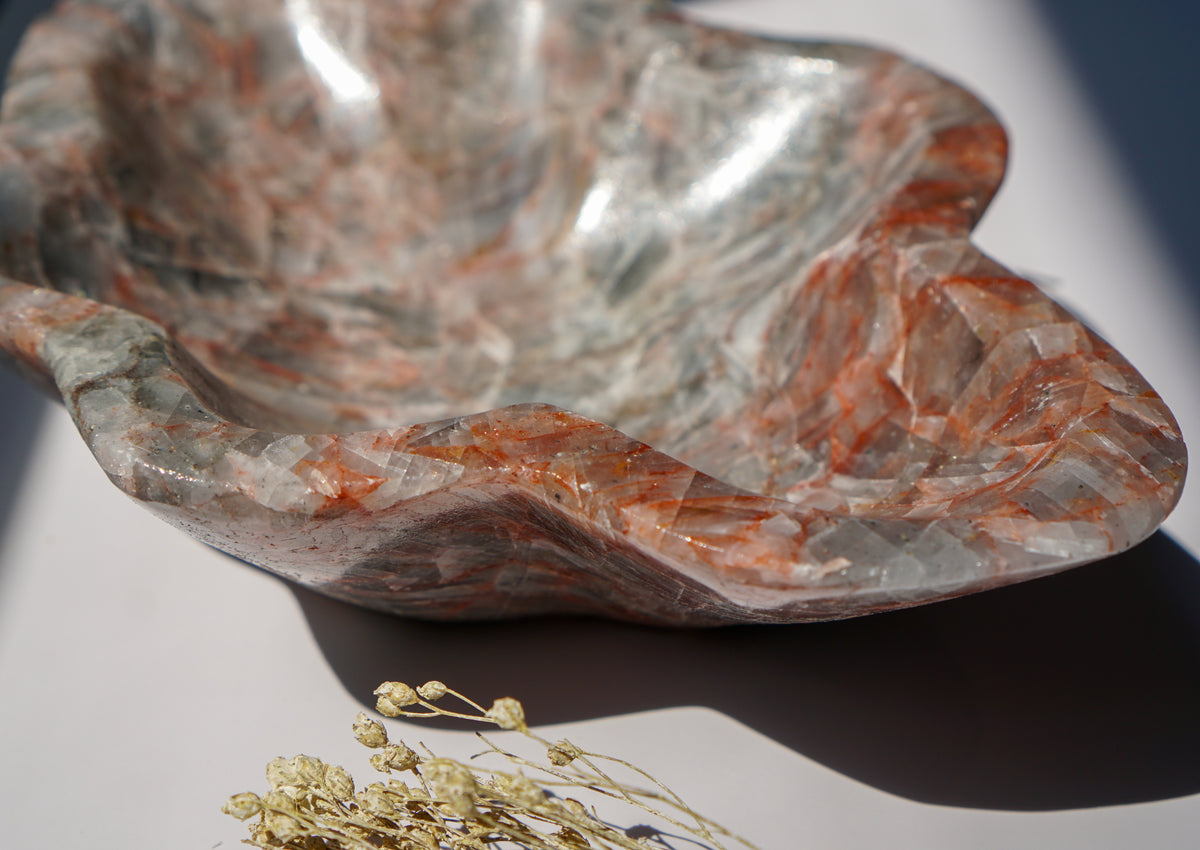 Close-up of Blue Calcite hematite bowl rim showing crystalline texture and rust-red veining