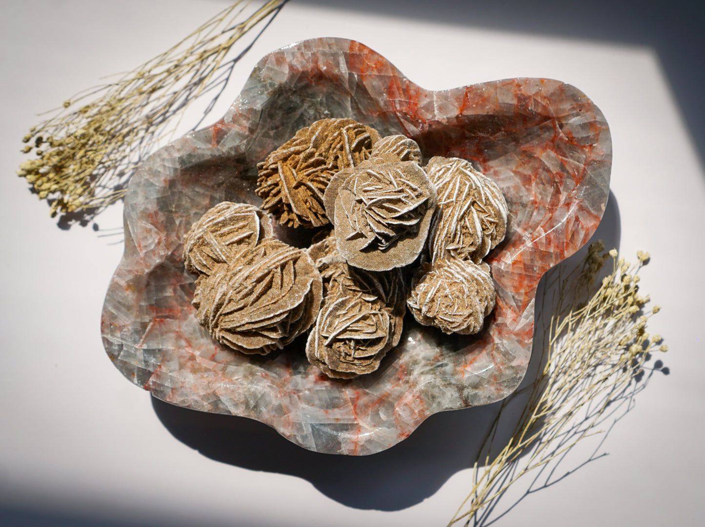 Hand carved Blue Calcite hematite bowl filled with desert rose selenite clusters, styled with dried florals