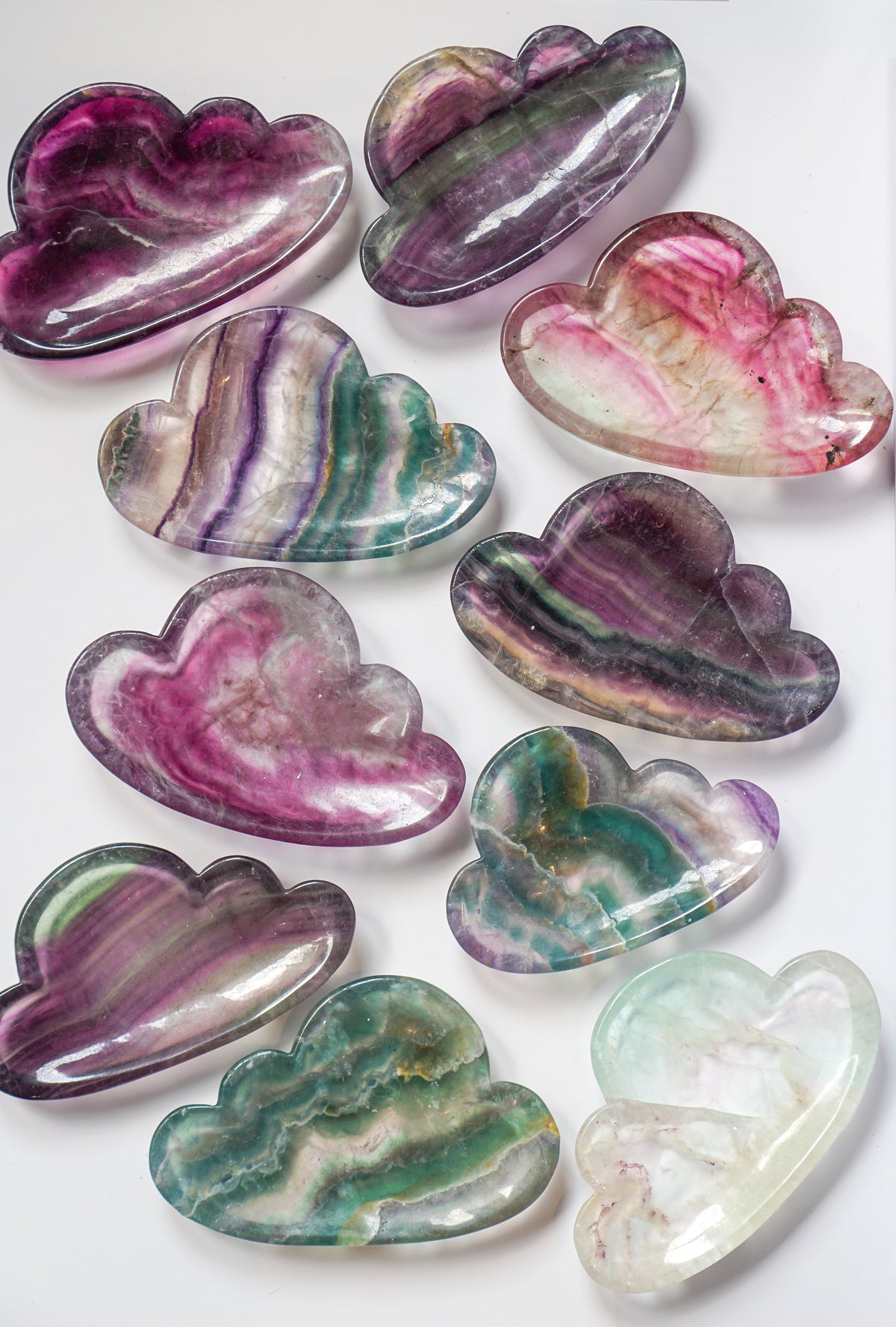 Full set of ten rainbow fluorite cloud dishes with citrine crystals and pampas grass, showing all colors together