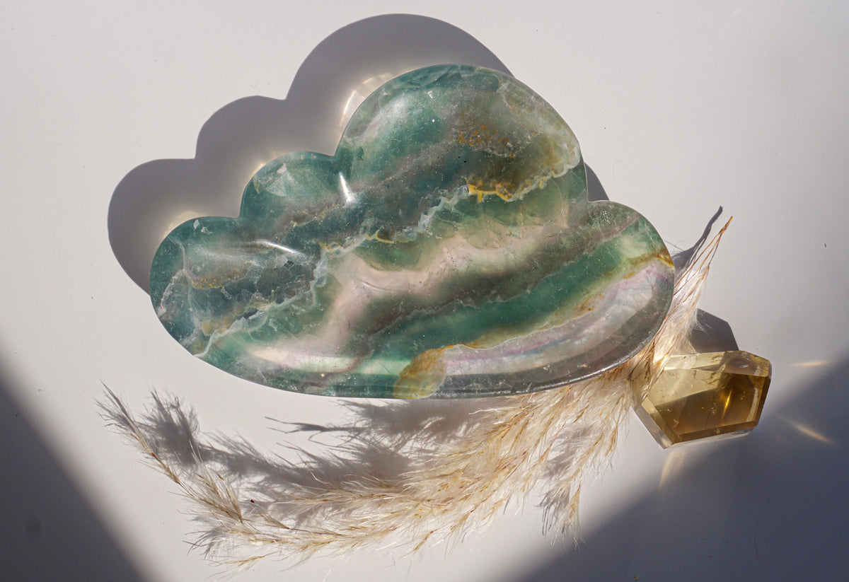 Rainbow fluorite cloud dish in emerald green with a citrine crystal point and dried pampas grass