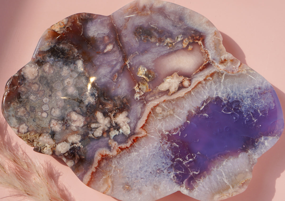 Close-up of Blue Flower Agate dish with lavender banding and natural druzy flower texture
